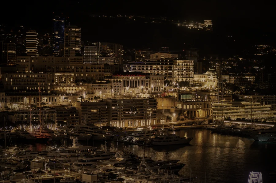 Monaco harbour lit gold at night
